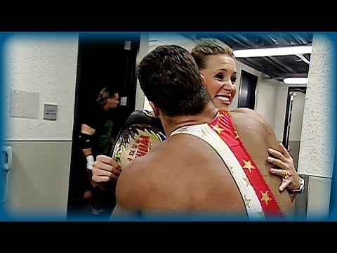 Stephanie McMahon and Kurt Angle hug in front of Triple H: SmackDown!, July 13, 2000