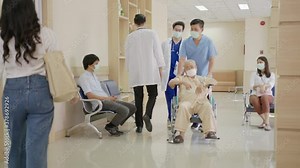 Busy hospital lobby or hallway with busy nurse, older patient on wheelchair, sick patient sitting, doctors walking relative waiting at reception wearing medical mask healthcare concept.