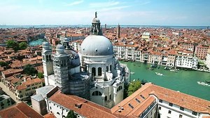Drone Venice Italy 4k. Salute Basilica in Venice, old architecture seen from Grand canal. Italy travel. Romantic honeymoon tourism. Famous cruise destination in Europe.