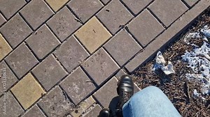 Women's legs walk down the street, first person view. A pedestrian's legs walk across a road zebra crossing. Close-up of human legs, walking outdoors. Spring, autumn or winter, comfortable shoes