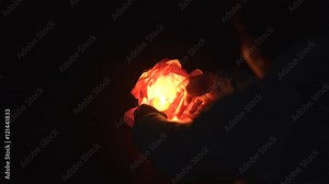 Man's hand puts water flashlight on the water. Running Water flashlight. Festival of water lanterns. Water lanterns on the water. The glow of lanterns on the water. Beautiful floating water lanterns.