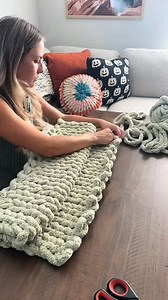 I made this cute little baby blanket for a customer 💚 #fyp #fingerknitting #chunkyblankettutorial #handknitblanket #falldecor #diyhomedecor #etsycreatorco #chenilleblanket #armknitting #diycrafts #handknit #sidehustle #newhobby #howtocrochet | WildlyWoven