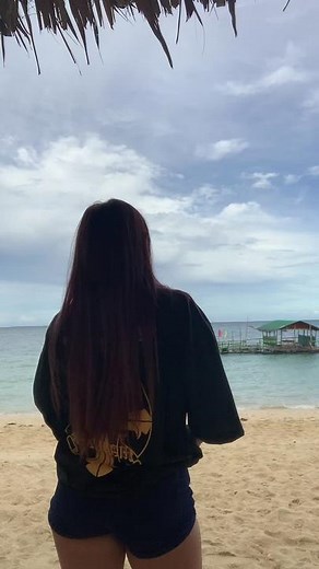 Serene Beach Moments: Young Woman Enjoys Ocean View