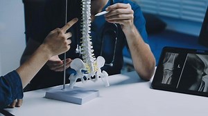 Download A doctor and patient working on a model of the spine for free
