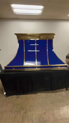 Rich color, refined details, and a little brass magic. This hood was made to be admired. RangeHoodDesign #CustomKitchen #KitchenInspo #BrassDetails #LuxuryKitchen #KitchenDesign