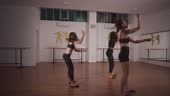 Three beautiful young girls practicing modern ballet dance in dance...