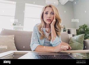 Photo portrait woman blonde hair sitting on sofa using laptop talking on video connection upset got problem Stock Photo - Alamy