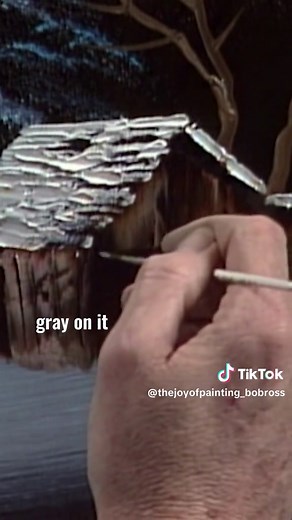 Bob Ross builds a cabin into his painting