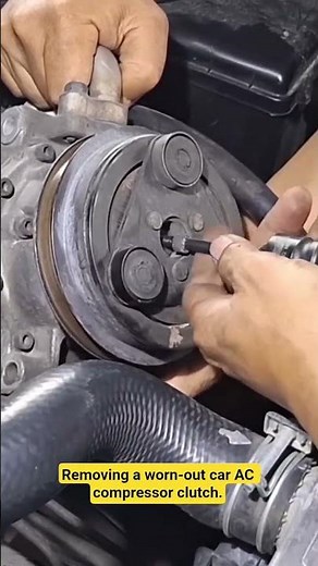Removing a worn-out car AC compressor clutch