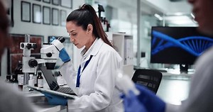 Medicine, woman and innovation with microscope, scientist and quality control for drug research, DNA and healthcare. Experiment, pharmaceutical and people with computer screen, analysis and medical