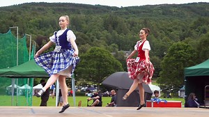 Local Perthshire competitors in the Blue Bonnets, Scottish Highland Dance competition, held during the 2024 Kenmore Highland Games. These friendly Games are held by Loch Tay at Kenmore in Perthshire, Scotland, one of the few evening Highland Games in Scotland. This national dance shows a young women trying to catch the attention of and flirt with a blue bonnet, slang for Scotsmen because they wore blue hats, traditionally with a clan badge and a sprig of the clan plant to signify allegiances. #h