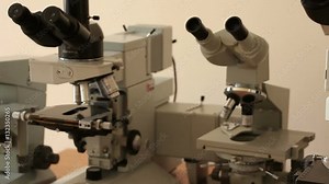 Microscopes horizontal panning. Focus on the microscope objectives in the beginning of panning. Another equipment is out of focus. Moving on the left. Stock Video