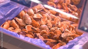 Frozen mussels. Seafood on the counter. Fish market. Box with fish. Wholesale of fish. Peeled mussels