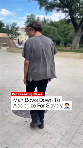 White liberal man bows before Black men and kisses their boots to apologize for slavery.Liberalism is a mental illness.