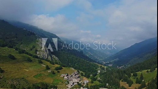 Stunning view of the Cottian Alps and the village of Busca in Italy below