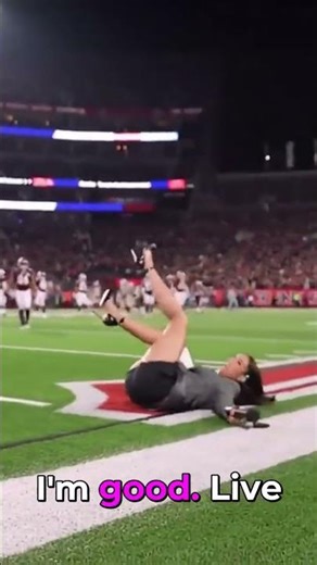 Female reporter stumbles and falls during live sideline broadcast.