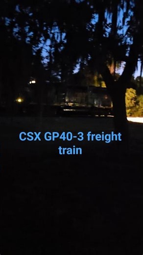 CSX GP40-3 freight train in the dusk.