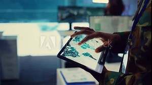 Army officer examines reconnaissance system on a world map, targeting enemy aircraft or warships on the national territory. Military personnel tracks status of deployed units. Close up. Camera B.