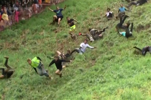 Cheese-rolling race in England showcases daredevils chasing cheese down a steep hill