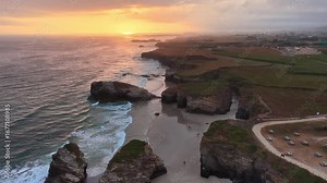 sunrise on the coast of Galicia in northern Spain, Playa de Las Catedrales beach in Galicia, tourism in northern Spain. Beautiful cliffs on famous Cathedral Beach, Cantabrian Coast