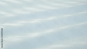 Beautiful moving background of light color, waves on fabric