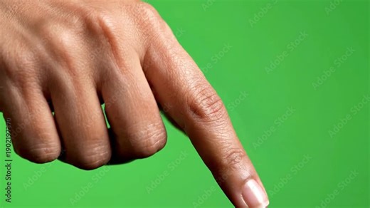 A hand with index finger pointing on a green screen background in a video