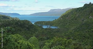 4k locked off motion view of Lake Tarawera and surrounding forest with a view of dormant Mount Tarawera volcano in the far background,Bay of Plenty,Rotorua,North Island,New Zealand