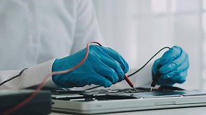 Download Debugging electronics device. PCB witch microcontroller in electronics laboratory for free