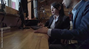 Business work colleagues working in teamwork on a desktop computer with keyboard in a colorful cool workspace for cowork, chatting, discussing, laughing and taking instructions. 4k 60fps stabilized Stock Video