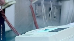 The doctor takes the defibrillator in his hands and puts the defibrillator in place Stock Video