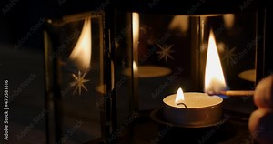 Slow motion of match igniting candle. Match Lighting Close-up Macro With Single Candle Flame Isolated on Black Background In Slow Motion, holiday, romance and Christmas concept.