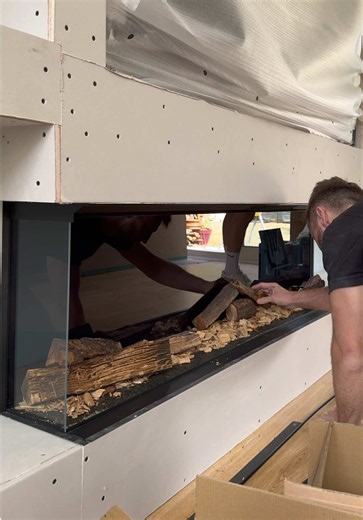 A huge 7-metre-wide media wall taking shape, complete with a stunning feature drop ceiling, bespoke alcoves, shelving and a beautiful panoramic fire. In this reel, you can see the process come together, framework and boarding, TV installation, and everything prepared and ready for plastering. #mediawall #beforeandafter #homeimprovement #featurewall #luxuryliving