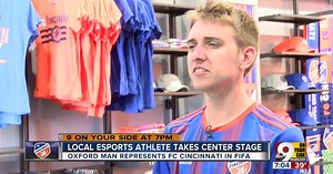 Local video gamer Gordon 'Fiddle' Thornsberry carries FC Cincinnati banner in eMLS