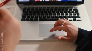 The hands of freelancers use the laptop's touchpad. She makes a choice with finger, presses. Search for information using high-speed internet. Transferring the command to the computer. Stock Video