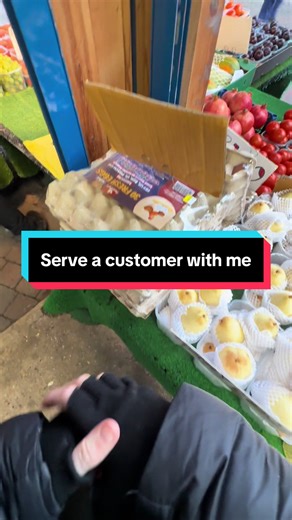 Serving Customers at a Small Fruit Stall
