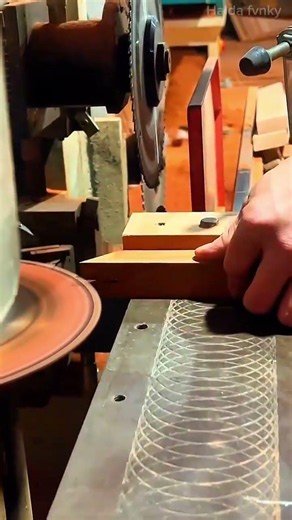 sharpening the edge of a small wooden block precisely using a spinning grinding wheel tool