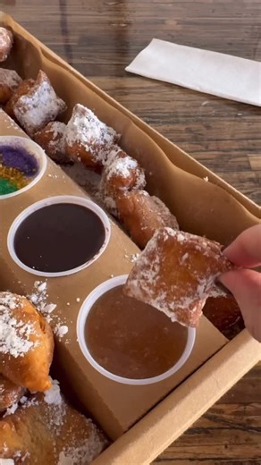UPDATE*** boxes have been upgraded to fit more beignet minis and a 5th syrup! We already sold out of the smaller boxes, so we upgraded to give you more! *** Now accepting pre-orders for the Mardi Gras Party Box! 🥳💜💛💚 Available for pre-order and pick up any day between now and fat Tuesday! Party Box Includes: 12pc cinnamon beignet minis, 12pc regular minis & 5 syrups: Mardi Gras cream cheese, cinnamon, buttercream, strawberry, and Grandma‘s chocolate gravy. (Or choose your own syrups!) -Click