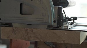 Download carpenter sawing a pine countertop with a plunge-cut saw for free