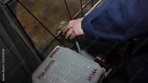 The crane operator’s hand moves the lever and controls the overhead crane. Video made close up.