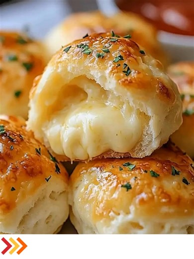 EGooey Mozzarella Biscuit Bombs Ingredients: - 1 can of refrigerated biscuit dough - 16 cubes of mozzarella cheese (about 1-inch each) - 4 tablespoons of melted butter - 1 teaspoon of garlic powder - 1 teaspoon of Italian seasoning ........ Full Recipe in Coʍmеոτ 💬 | Cook By Book