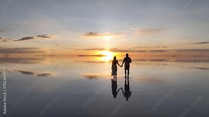 Salar de Uyuni in Bolivia during sunset. Aerial image taken with a drone. Uyuni Salt Flats. Altiplano, Bolivia. Rainy Season. Tunupa Volcano. Clouds Reflection on Water in Lake Surface