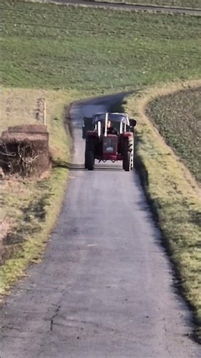 Tractor IHC 644 with heavy trailer pulling up a steep hill