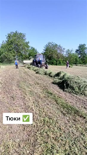 Tractor Baling Hay in Open Field