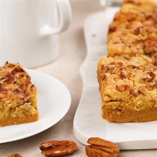 Pumpkin Crunch Cake is brimming with fall flavors. Top each slice with a dollop of whipped cream and chopped pecans to create the perfect pumpkin dessert. https://www.mybakingaddiction.com/pumpkin-crunch-cake/ | My Baking Addiction
