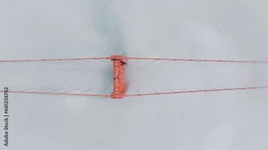 Birds eye view of Golden Gate Bridge with heavy traffic in foggy clouds, San Francisco, California, USA. Top shot of red bridge surrounded Karl the fog. Busy morning road on way to city, 4k footage