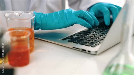Laboratory healthcare researcher team with scientific expertise, lab equipment, and innovative medical biotechnology software in laptop, research new medicines, develop cure. Slow motion. Rigid.