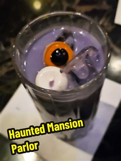 Ghoulish Delight 👁 at Haunted Mansion Parlor ube milk, tapioca pearls, shimmer, and eyeball gummies