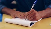 4k footage of a student making notes in his notepad