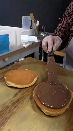 Garnishing the Pancakes with Chocolate. Italian Food Festivam