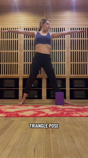 Triangle pose is a great way to open the hips, stretch the hamstrings, and lengthen the side body. Start by stepping your feet wide apart. Turn your front toes forward and your back foot slightly inward. Reach your arms out to the sides like a T and engage both legs. Begin to hinge forward from your front hip while keeping your chest open. Let your front hand rest on your shin, ankle, or a block while your top arm reaches toward the sky. Keep both legs strong and your gaze either forward or up t